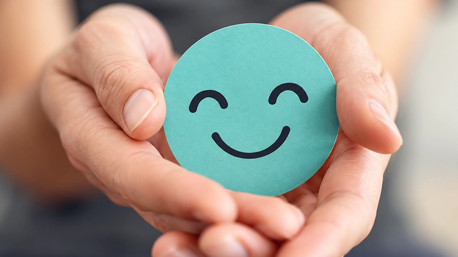 Qualisus Consulting Hands Offering a Teal Smiley Token Qualisus Consulting Hands Offering a Teal Smiley Token