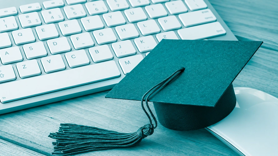 Qualisus Consulting Teal Graduation Cap on Desk Qualisus Consulting Teal Graduation Cap on Desk